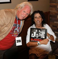 Alice Cooper holding Rock & Rowlands Flashback with John Rowlands