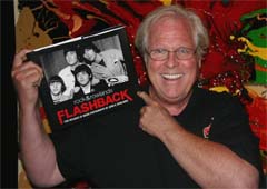 The photographer John Rowlands with the Rock & Rowlands Flashback book